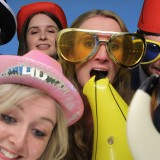Five friends in hats and glasses dressed to impress in an image taken by a photo booth hire in Wimbledon, London
