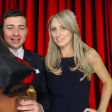 couple enjoying photo booth fun at wedding party in hose in wimbledon