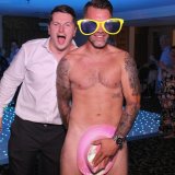 Cheeky lads at a wedding giving a unique pose in front of a magic mirror photo booth