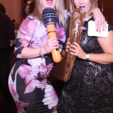 Two youg ladies taking photos using a magic mirror photo booth
