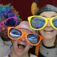 Three colleagues having fun in a photo booth hired at Glenmore House